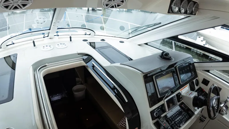 Slide: The Image of 2009 Sea Ray 470 Sundancer helm with navigation controls and panoramic windows. - 22