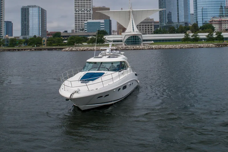 Slide: The Image of 2009 Sea Ray 470 Sundancer yacht cruising near city waterfront skyline. - 3