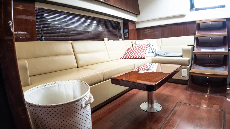 Slide: The Image of Luxurious interior of 2009 Sea Ray 470 Sundancer yacht with beige seating and wooden accents. - 32
