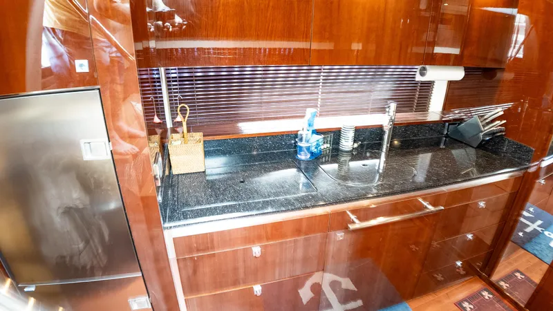 Slide: The Image of Luxurious kitchen area in 2009 Sea Ray 470 Sundancer yacht with sleek wood cabinetry. - 34