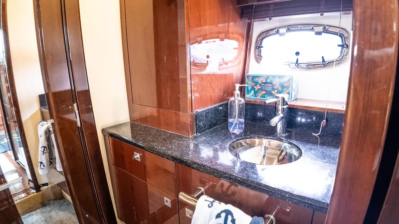 Slide: The Image of Luxurious bathroom interior of 2009 Sea Ray 470 Sundancer yacht with sleek wood finish. - 36