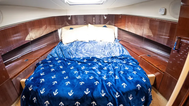 Slide: The Image of Luxurious cabin interior of 2009 Sea Ray 470 Sundancer with plush bedding. - 45