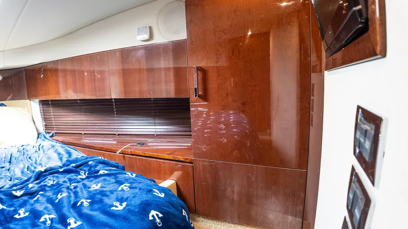Slide: The Image of Luxurious cabin interior of 2009 Sea Ray 470 Sundancer with wood paneling and cozy bedding. - 47