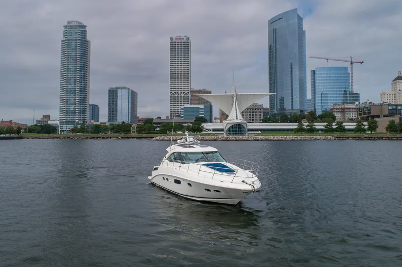 Slide: The Image of 2009 Sea Ray 470 Sundancer yacht on urban waterfront with skyscrapers in background. - 8