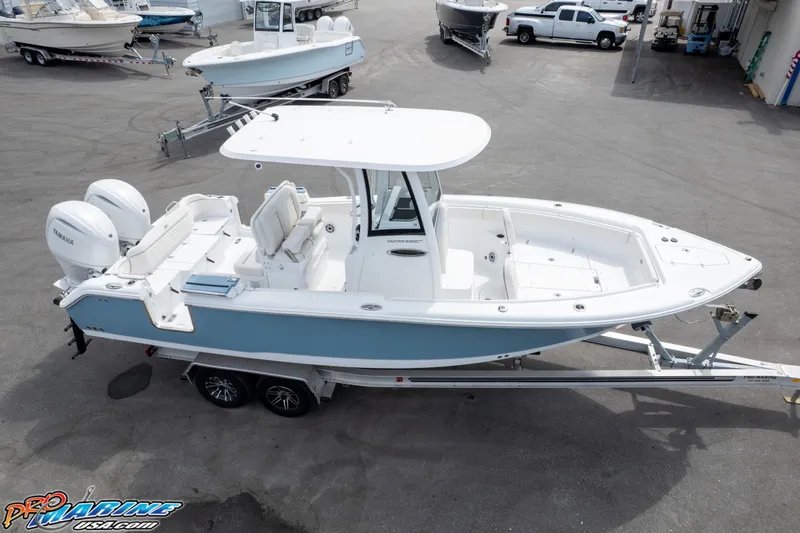 Slide: The Image of 2026 Sea Hunt Ultra 265 SE boat on trailer, parked in a marina lot. - 11