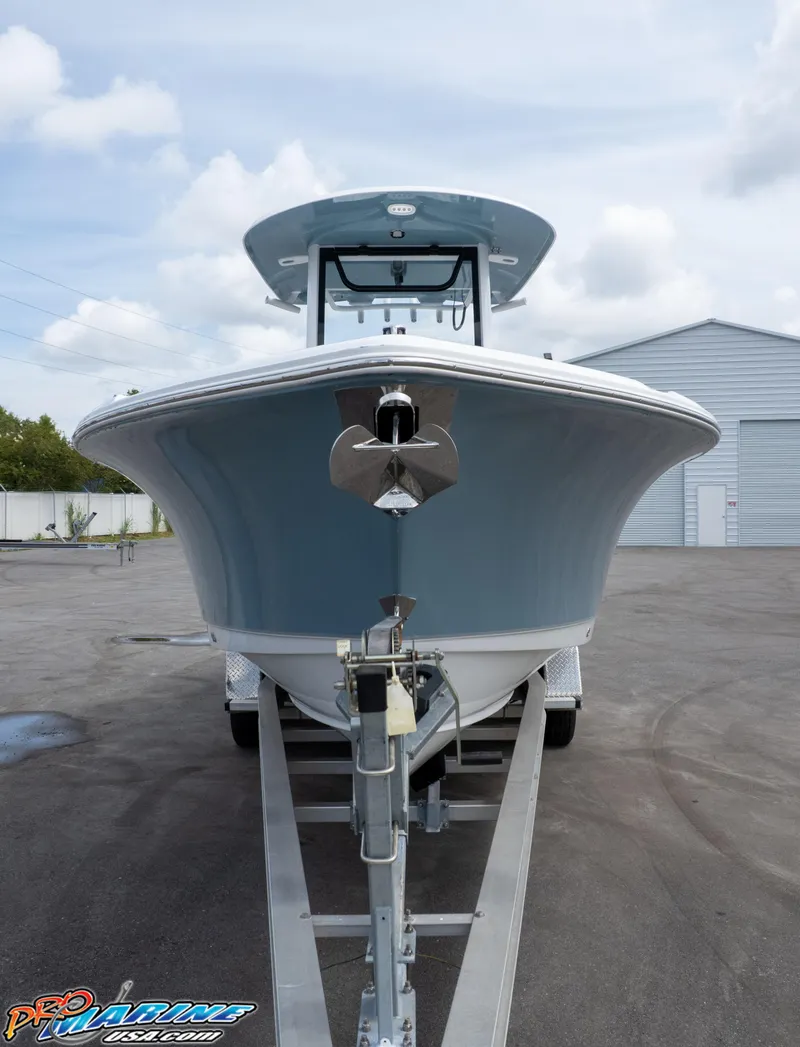 Slide: The Image of 2026 Sea Hunt Ultra 265 SE boat on trailer, front view, parked outdoors. - 13