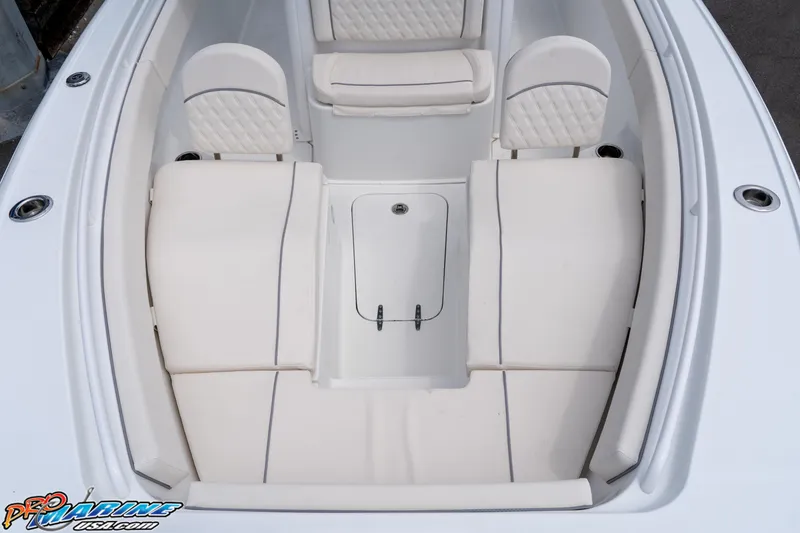 Slide: The Image of 2026 Sea Hunt Ultra 265 SE boat interior with white cushioned seating. - 15