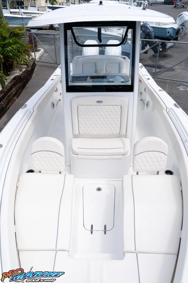 Slide: The Image of 2026 Sea Hunt Ultra 265 SE boat interior with white seating and modern design. - 16