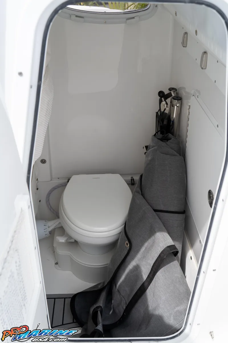 Slide: The Image of 2026 Sea Hunt Ultra 265 SE boat interior with compact marine toilet. - 20