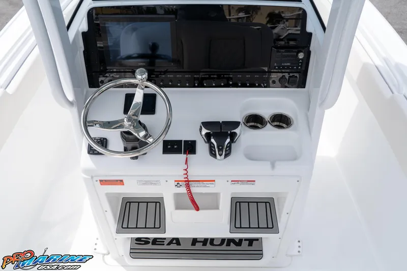 Slide: The Image of 2026 Sea Hunt Ultra 265 SE boat console with steering wheel and controls. - 25