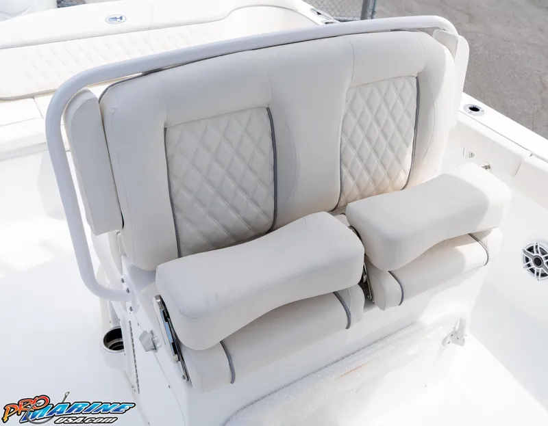 Slide: The Image of 2026 Sea Hunt Ultra 265 SE boat seating with cushioned armrests and diamond-pattern upholstery. - 26