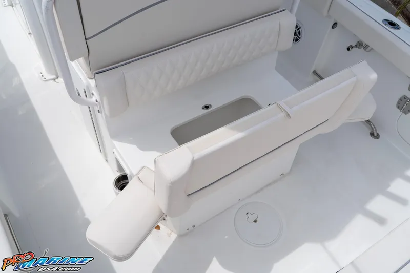 Slide: The Image of 2026 Sea Hunt Ultra 265 SE boat seating area with white upholstery and storage compartment. - 30