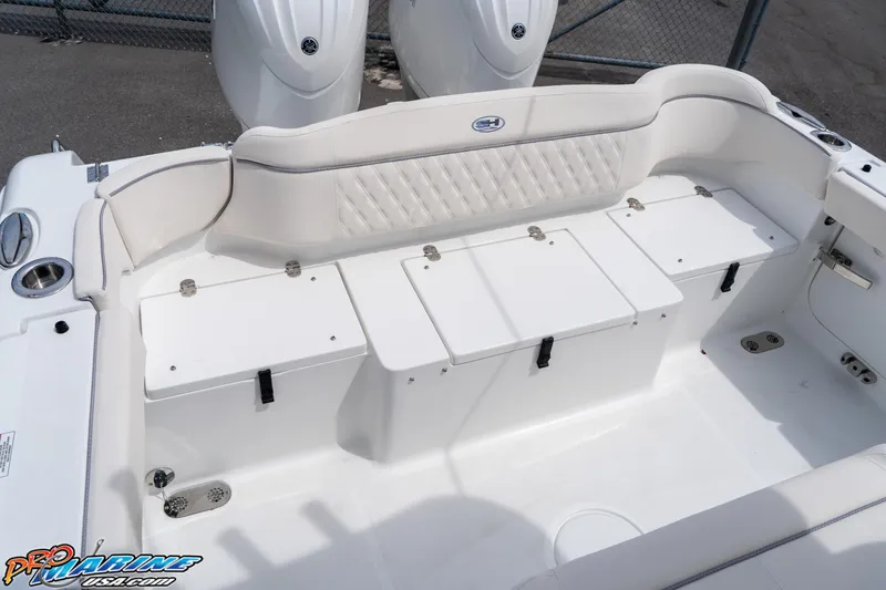 Slide: The Image of 2026 Sea Hunt Ultra 265 SE boat interior with white seating and storage compartments. - 31