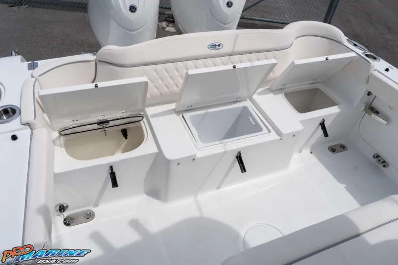 Slide: The Image of 2026 Sea Hunt Ultra 265 SE boat storage compartments open, showcasing interior features. - 32