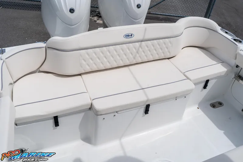 Slide: The Image of 2026 Sea Hunt Ultra 265 SE boat with white cushioned seating. - 33