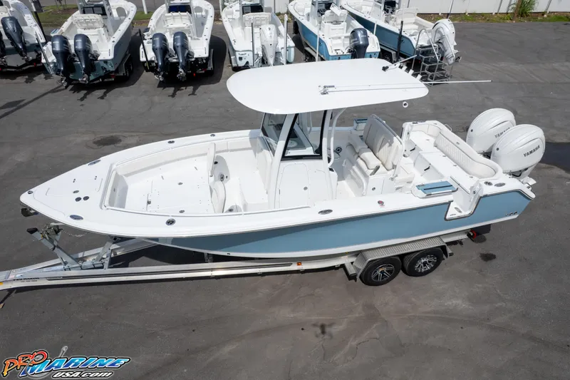 Slide: The Image of 2026 Sea Hunt Ultra 265 SE boat on trailer, surrounded by other boats. - 5