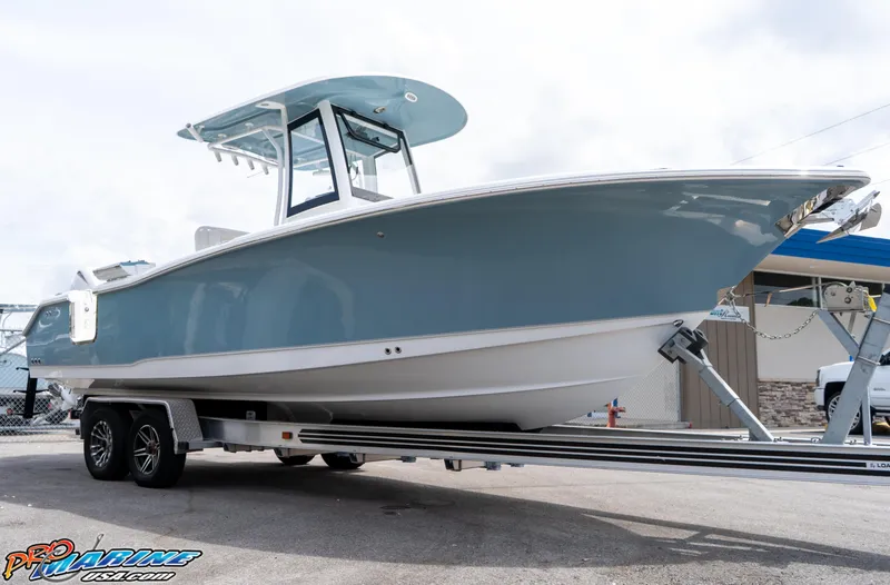 Slide: The Image of 2026 Sea Hunt Ultra 265 SE boat on trailer, displayed outdoors. - 9