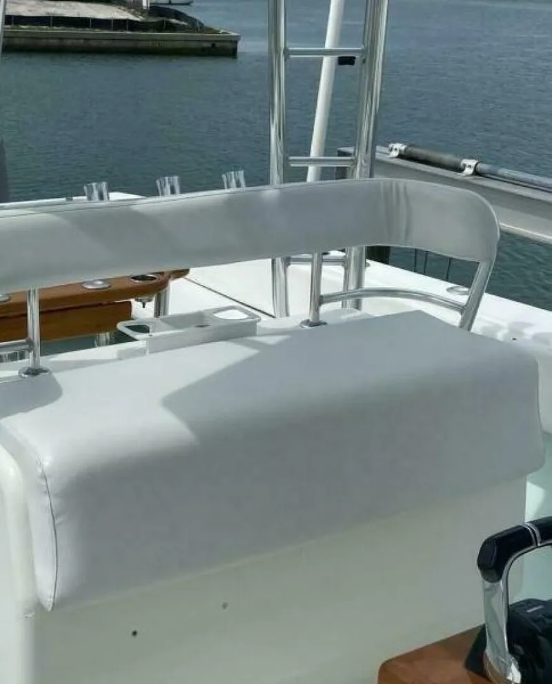 Slide: The Image of 2012 Contender 39ST boat seating area with white upholstery and chrome accents. - 10