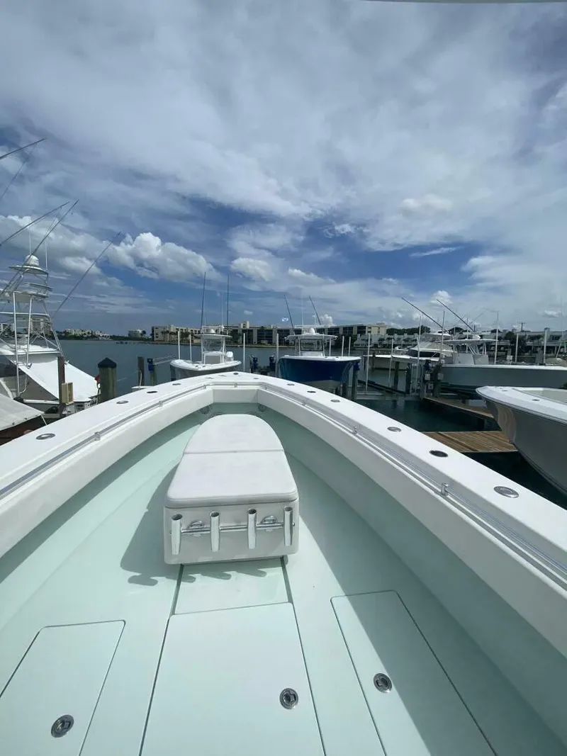 Slide: The Image of 2012 Contender 39ST boat docked at marina under cloudy sky. - 5