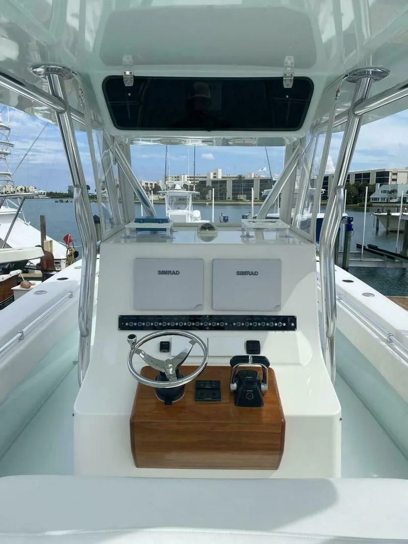 Slide: The Image of 2012 Contender 39ST boat helm with dual Simrad displays, docked at marina. - 7