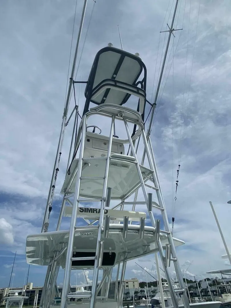 Slide: The Image of 2012 Contender 39ST boat tower with multiple levels against a cloudy sky. - 8