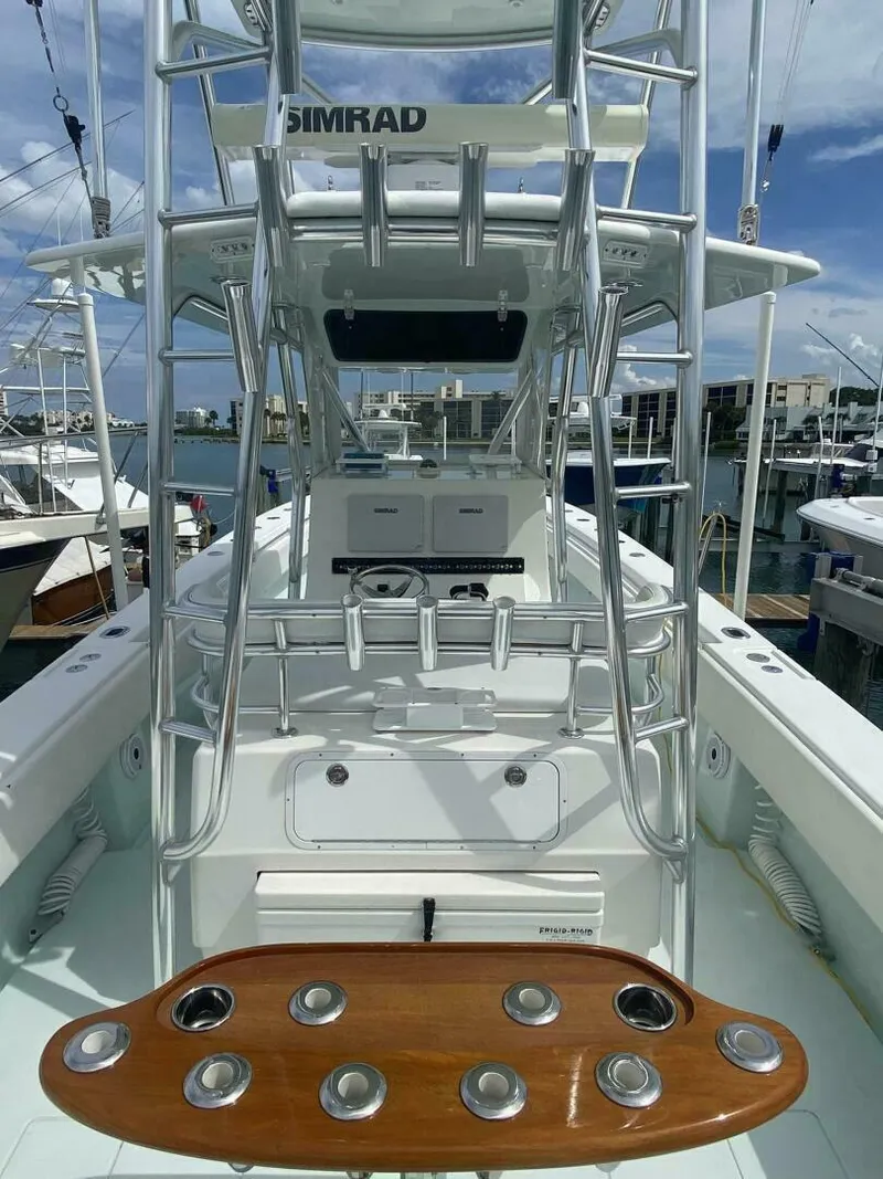 Slide: The Image of 2012 Contender 39ST boat with Simrad equipment, docked at a marina. - 9