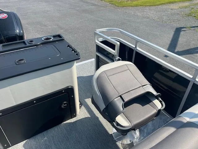 Slide: The Image of 2026 Sun Tracker Fishin' Barge 20 DLX interior with seating and storage. - 11