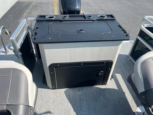 Slide: The Image of 2026 Sun Tracker Fishin' Barge 20 DLX boat interior with seating and storage unit. - 12