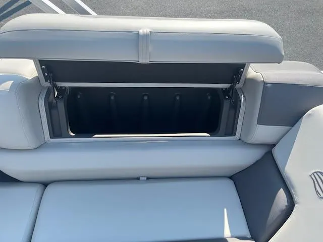 Slide: The Image of Open storage compartment on 2026 Sun Tracker Fishin' Barge 20 DLX boat seat. - 13