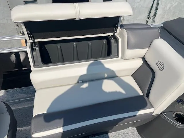 Slide: The Image of 2026 Sun Tracker Fishin' Barge 20 DLX boat seat with open storage compartment. - 17