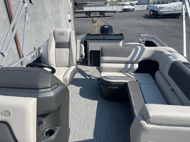 Slide: The Image of 2026 Sun Tracker Fishin' Barge 20 DLX interior with seating and steering console. - 18