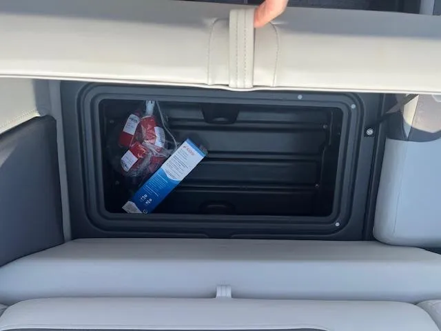 Slide: The Image of Storage compartment in 2026 Sun Tracker Fishin' Barge 20 DLX with snacks inside. - 19