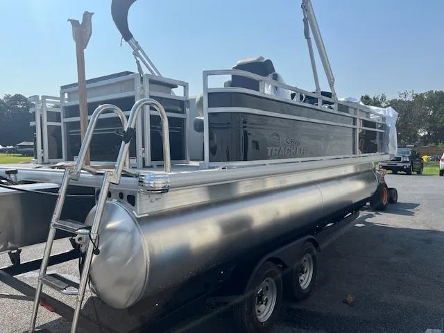 Slide: The Image of 2026 Sun Tracker Fishin' Barge 20 DLX pontoon boat on trailer, side view. - 6