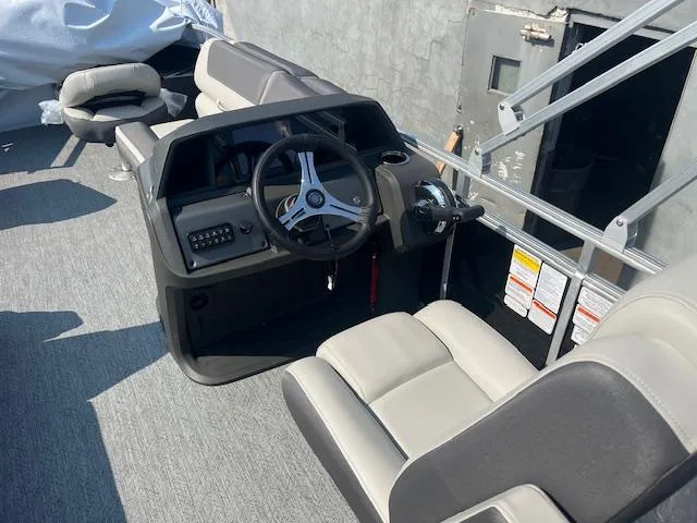 Slide: The Image of 2026 Sun Tracker Fishin' Barge 20 DLX interior with steering console and seating. - 9