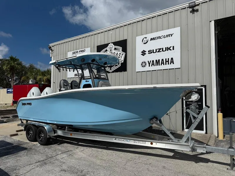 Slide: The Image of 2026 Sea Pro 262 Offshore boat on trailer outside dealership, featuring Yamaha and Suzuki signage. - 1