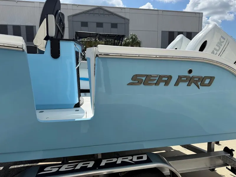 Slide: The Image of 2026 Sea Pro 262 Offshore boat in light blue, parked on a trailer. - 10