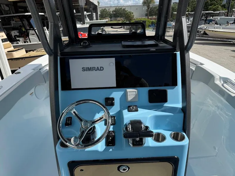 Slide: The Image of 2026 Sea Pro 262 Offshore boat console with Simrad display and steering wheel. - 11