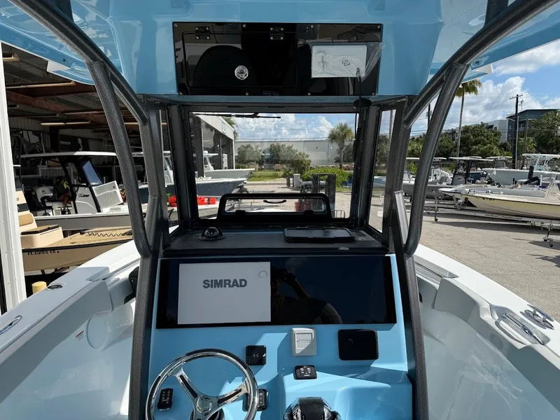 Slide: The Image of 2026 Sea Pro 262 Offshore boat dashboard with Simrad display and steering wheel. - 12