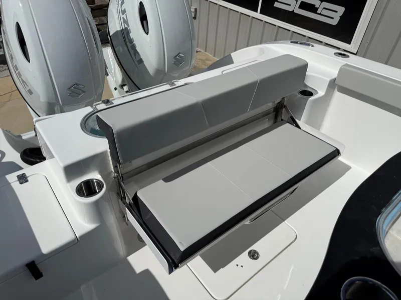 Slide: The Image of 2026 Sea Pro 262 Offshore boat with foldable seating and dual Suzuki outboard engines. - 14