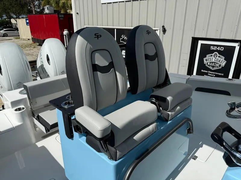 Slide: The Image of 2026 Sea Pro 262 Offshore boat seats with cup holders, displayed at West Coast Marine. - 17