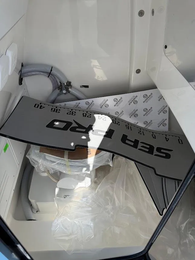 Slide: The Image of Interior of 2026 Sea Pro 262 Offshore boat with equipment and storage area. - 19