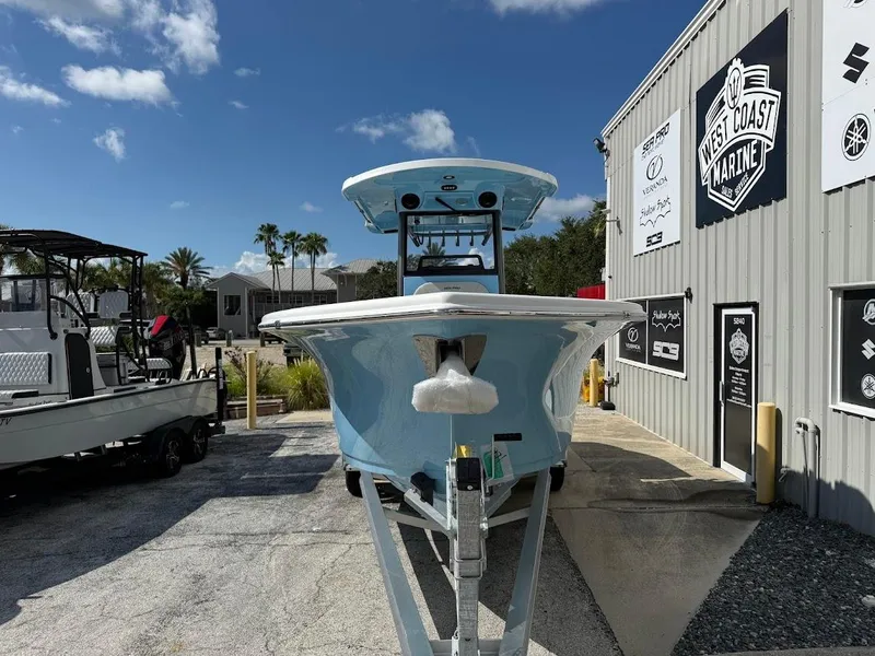 Slide: The Image of 2026 Sea Pro 262 Offshore boat at West Coast Marine dealership, sunny day. - 2