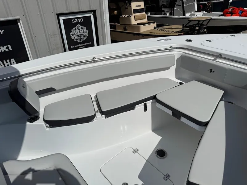 Slide: The Image of 2026 Sea Pro 262 Offshore boat interior with cushioned seating and storage compartments. - 22