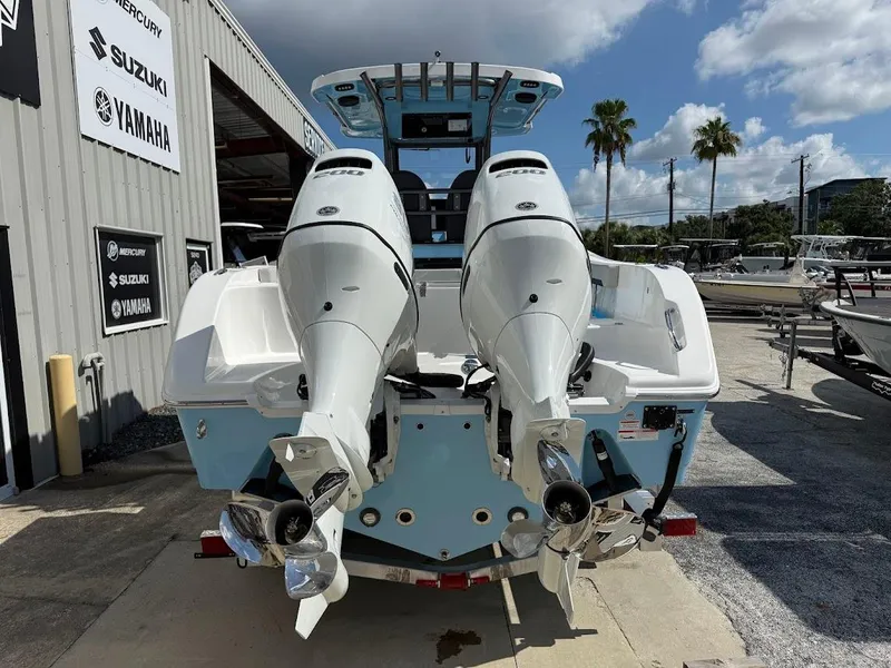 Slide: The Image of 2026 Sea Pro 262 Offshore boat with dual outboard engines at a dealership. - 7