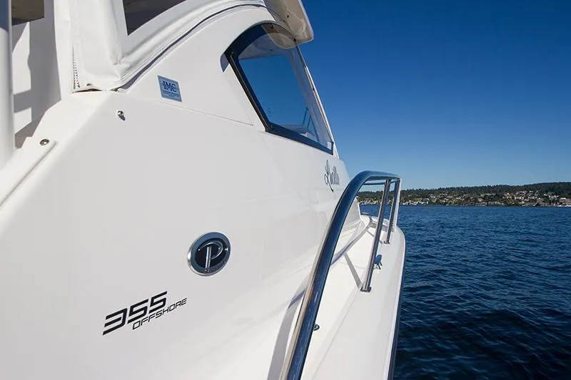 Slide: The Image of 2018 Pursuit OS 355 Offshore boat on calm blue water under clear sky. - 16