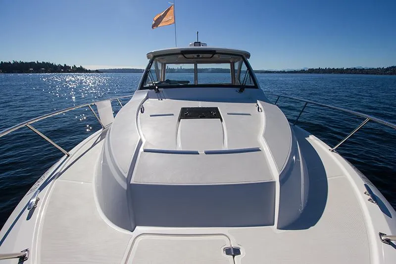 Slide: The Image of 2018 Pursuit OS 355 Offshore boat on calm water under clear blue sky. - 17