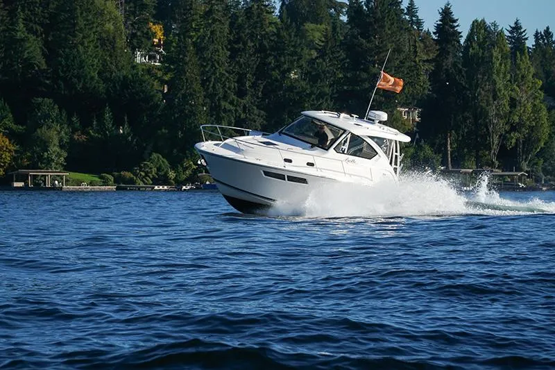 Slide: The Image of 2018 Pursuit OS 355 Offshore cruising on a scenic lake with forested shoreline. - 19