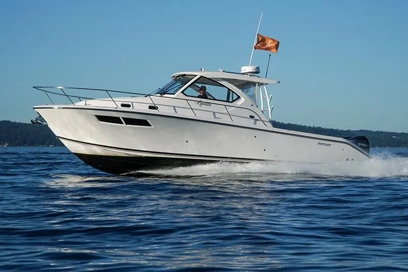Slide: The Image of 2018 Pursuit OS 355 Offshore boat cruising on open water under clear blue sky. - 20