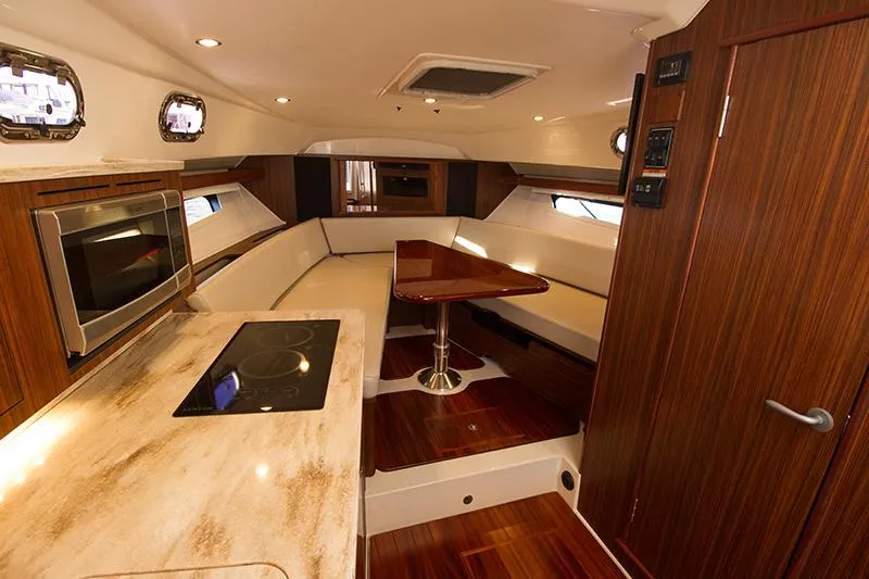 Slide: The Image of Luxurious interior of 2018 Pursuit OS 355 Offshore yacht with modern kitchen and seating area. - 9
