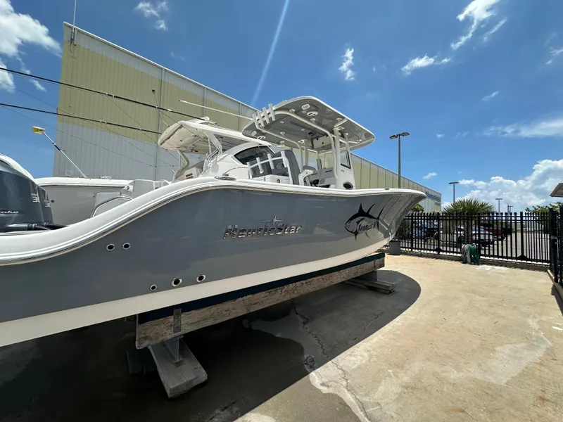 The Image of 2021 NauticStar 28XS boat on display under a clear blue sky. - 1